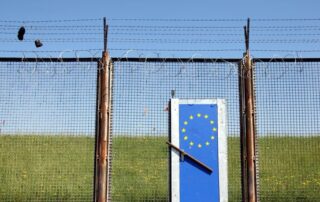 Symbolic picture of a closed border with EU logo on the door